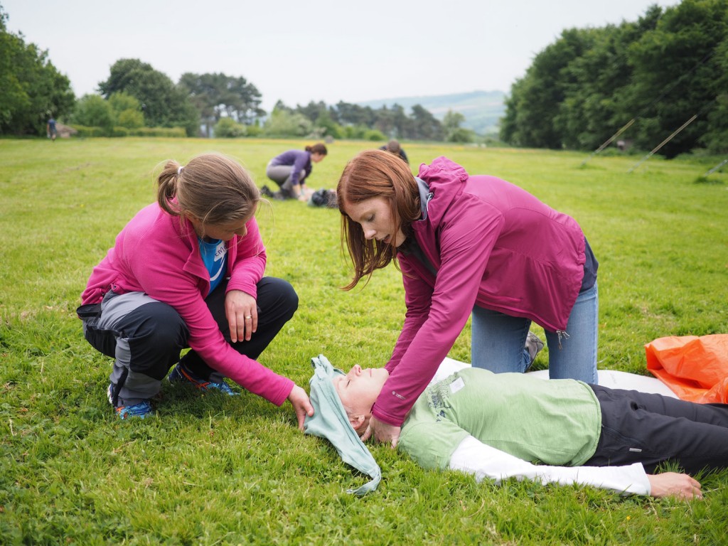 2 adults performing first aid