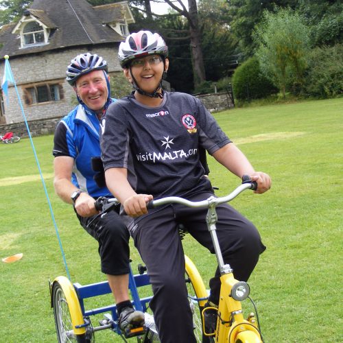 Adult and child on a accessibility trike