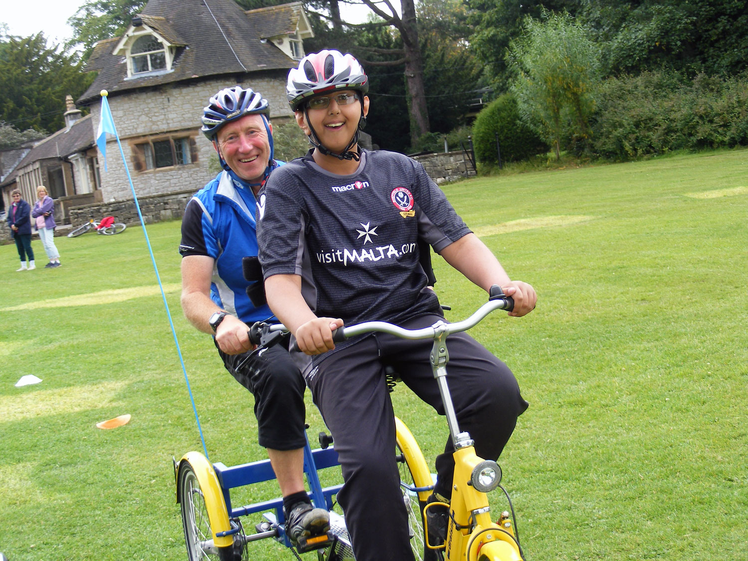 Adult and child on a accessibility trike