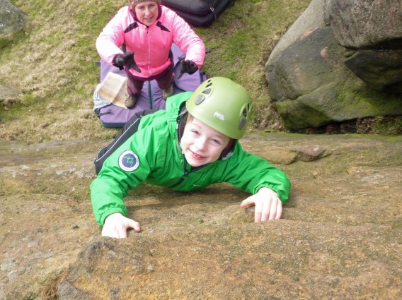 A pupil bouldering (rock based activity) in the Peak District