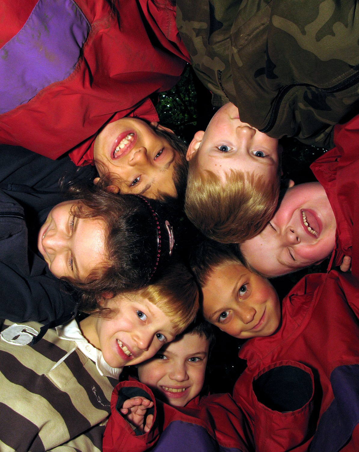 Children smiling outdoors on a brilliant residential