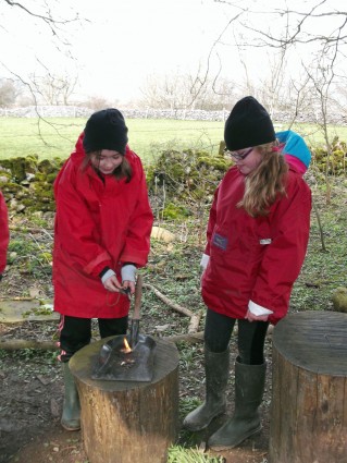 2 children fire lighting (onsite ground-based) at Thornbridge Outdoors