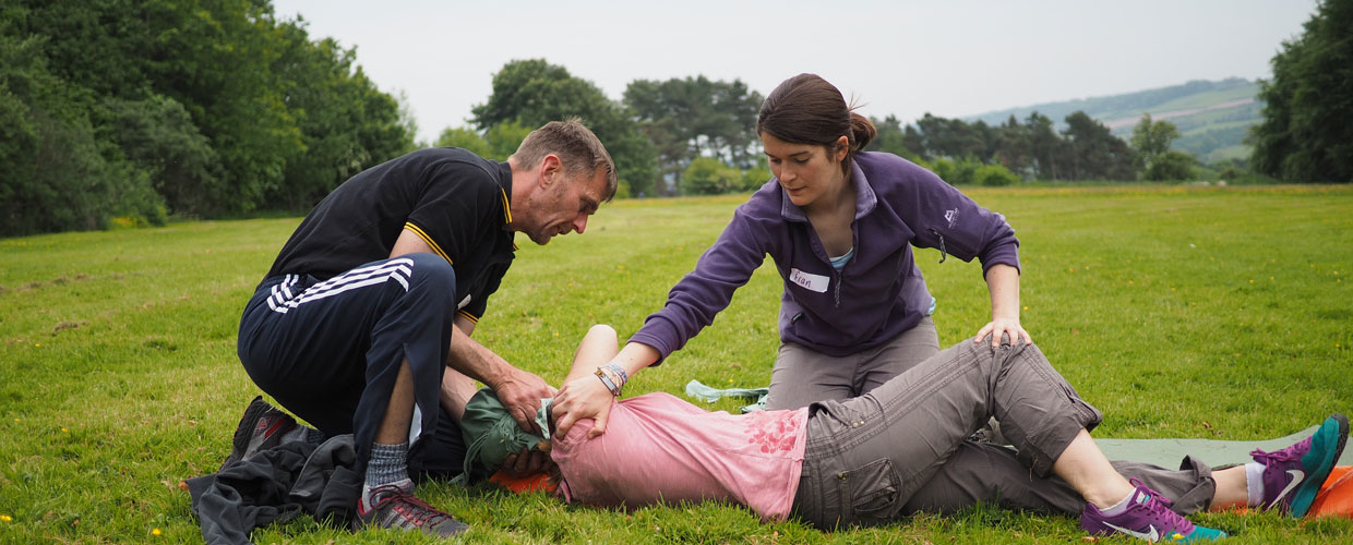 2 adults performing first aid