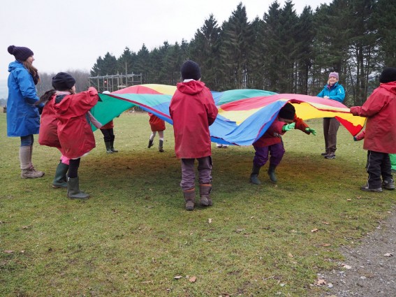 Pupils playing parachute games (onsite ground-based) at Thornbridge Outdoors