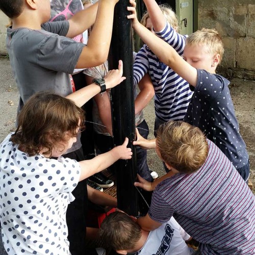 Pupils participating in a problem solving activity (onsite ground-based) at Thornbridge Outdoors