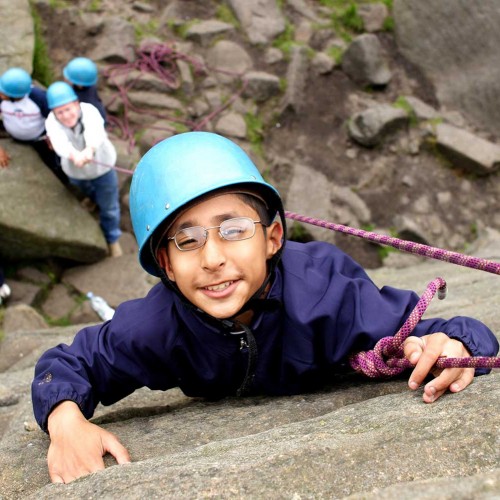 Pupil rock climbing in the Peak District