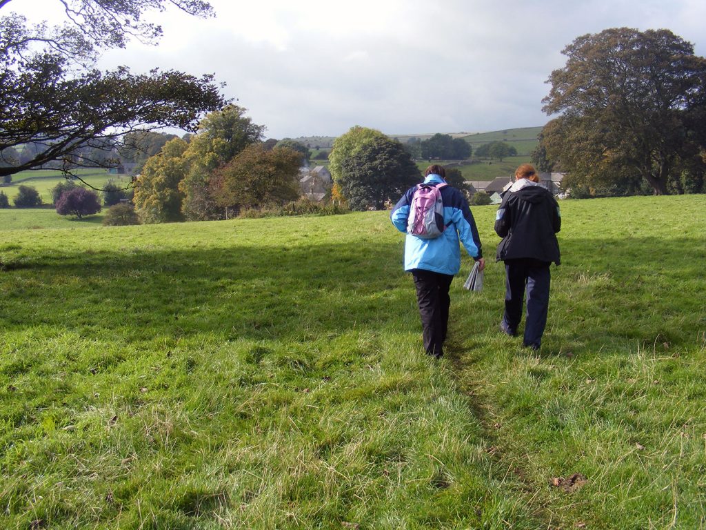 2 people waking on a footpath