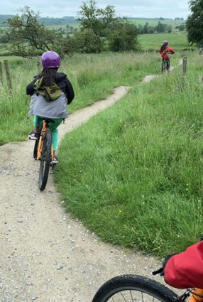 Children ride bikes in the grounds of Thornbridge Outdoors