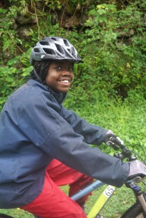 Boy smiles as he rides his bike